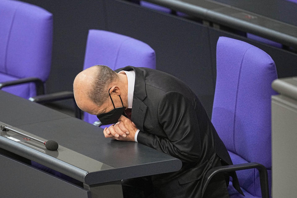 Newly elected German Chancellor Olaf Scholz, gestures as he sits in the gallery prior to his swearing-in ceremony, at the German Parliament Bundestag in Berlin, Wednesday, Dec. 8, 2021. Scholz has become Germany's ninth post-World War II chancellor, opening a new era for the European Union’s most populous nation and largest economy after Angela Merkel’s 16-year tenure. Scholz’s government takes office with high hopes of modernizing Germany and combating climate change but faces the immediate challenge of handling the country’s toughest phase yet of the coronavirus pandemic. (Michael Kappeler/dpa via AP)