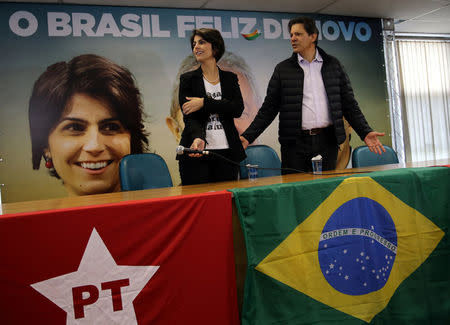 Fernando Haddad (R), former Sao Paulo mayor and member of Workers' Party (PT), and Manuela D'avila of the Communist Party of Brazil (PCdoB) attend a media conference in Sao Paulo, Brazil August 7, 2018. REUTERS/Paulo Whitaker