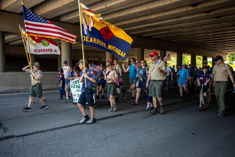 Multiple troops of Dearborn Scouts BSA walk, run and scooter during the 96th Memorial Day Parade along Michigan Avenue in Dearborn on Monday, May 30, 2022. The parade returns after a two-year hiatus due to the pandemic.