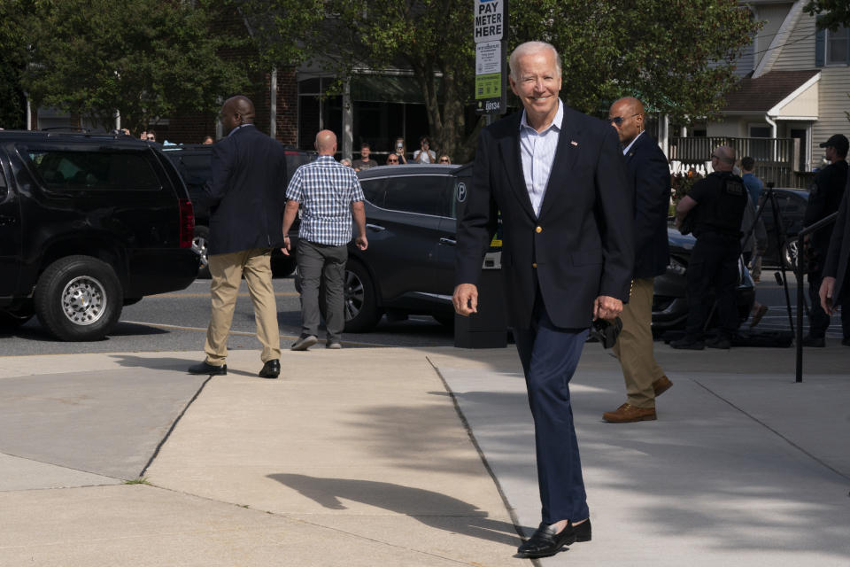 President Joe Biden reacts when asked how he was feeling as he leaves St. Edmund Roman Catholic Church in Rehoboth Beach, Del., after attending a Mass, Saturday, June 18, 2022. Bystanders cheered as he was asked how he was feeling. He smiled, and took three hops forward, making a jump-rope motion with his hands. (AP Photo/Manuel Balce Ceneta)