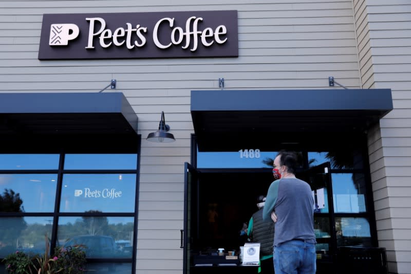 FILE PHOTO: Customers wear masks as they wait in line at a Peet's coffee shop in Encinitas, California