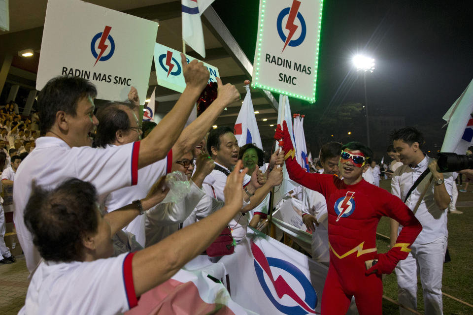 In this photo taken Friday, Sept. 11, 2015, supporters of Prime Minister Lee Hsien Loong's People's Action Party (PAP) cheer as they wait for elections results at an assembly center in Singapore. Every four or five years Singaporeans vote in general elections without ever asking the question which party can best run the government. That's a no-brainer It's the same party that’s been ruling the wealthy Southeast Asian city-state for half-century. (AP Photo/Ng Han Guan)