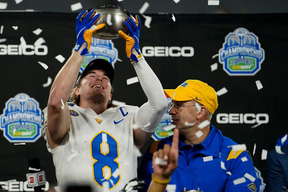 QB Kenny Pickett and head coach Pat Narduzzi celebrate their win against Wake Forest in the Atlantic Coast Conference championship game Saturday.