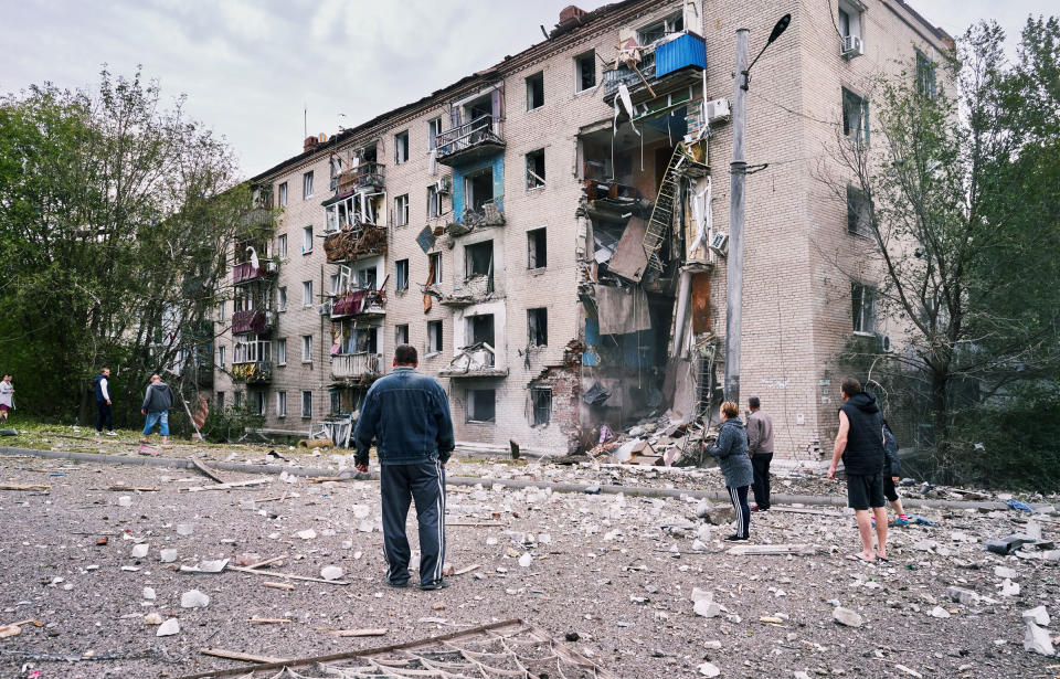 People gather to look at an apartment building damaged by two Russian rockets that hit earlier on Sept. 11, 2022, at around three o'clock in the afternoon, in Donetsk, Ukraine.<span class="copyright">Iva Zimova—Panos Pictures/Redux</span>