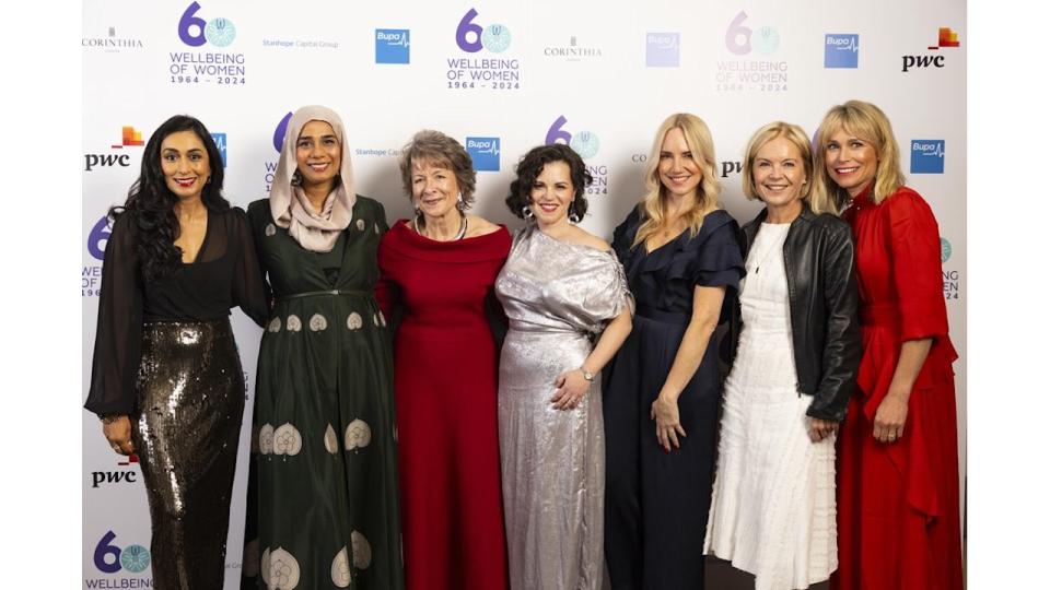 group of women smiling in formal clothes