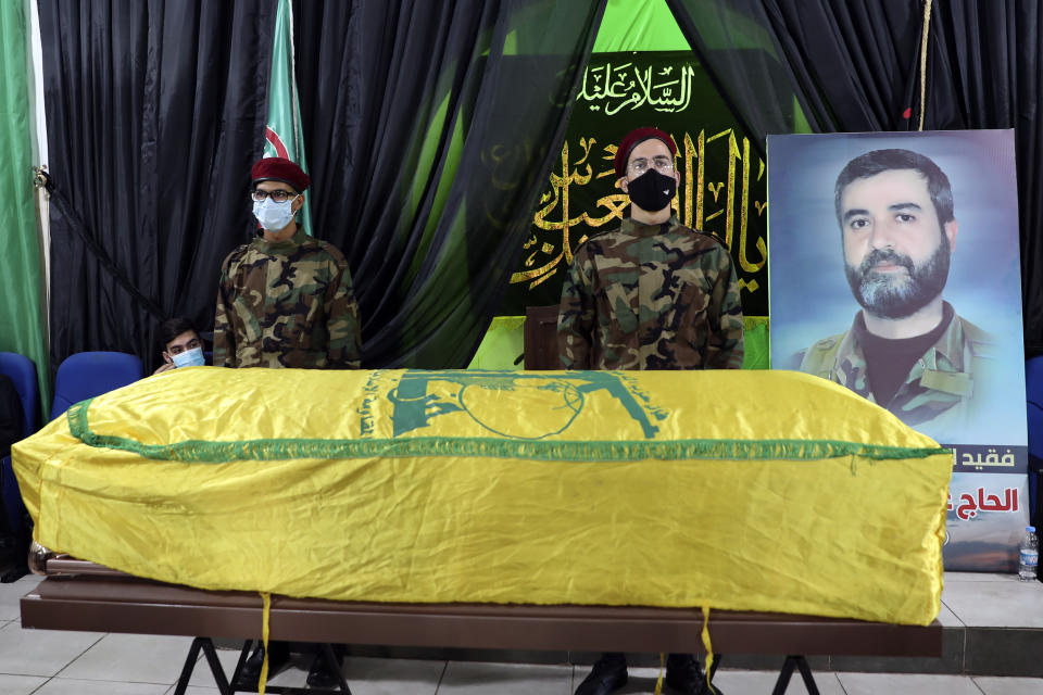 Hezbollah fighters stand in front of the coffin of Ali Atwa, a senior Hezbollah operative, during his funeral procession in the southern Beirut suburb of Dahiyeh, Lebanon, Saturday, Oct. 9, 2021. Atwa was placed on the FBI's most wanted list in 2001, with two other alleged participants in the 1985 hijacking of TWA Flight 847, one of the worst hijackings in aviation history and that lasted for 16 days. (AP Photo/Bilal Hussein)