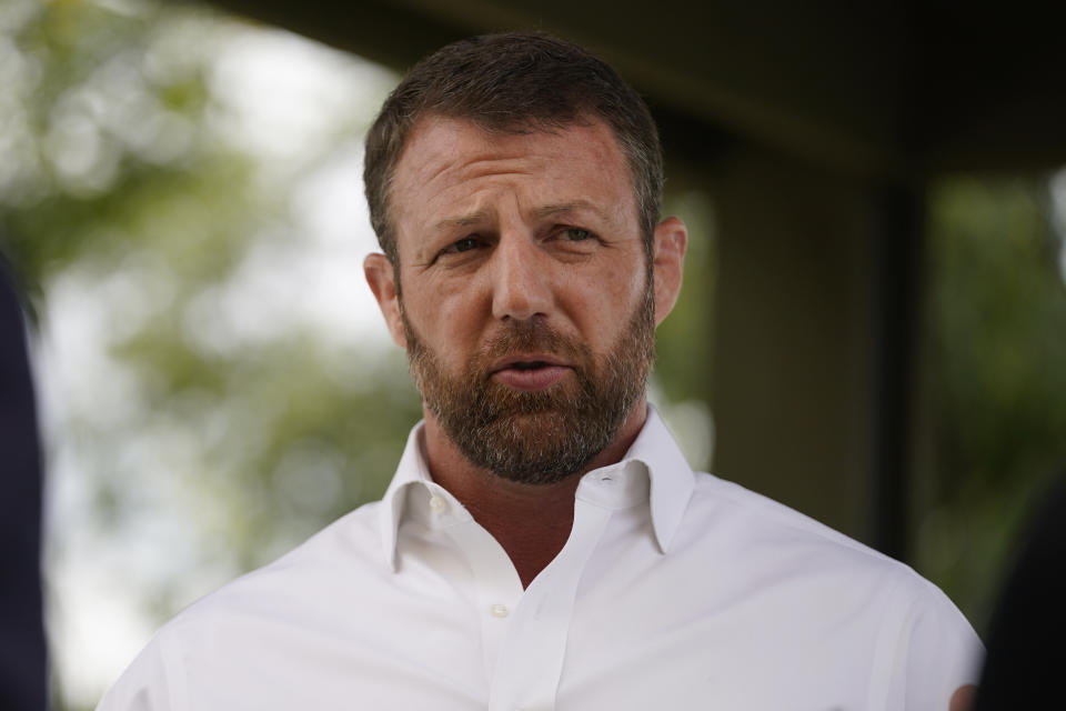 U.S. Rep. Markwayne Mullin, candidate in the Oklahoma Republican Primary runoff election for U.S. Senate, speaks with the media outside a luncheon Tuesday, Aug. 23, 2022, at a luncheon in Norman, Okla. (AP Photo/Sue Ogrocki)