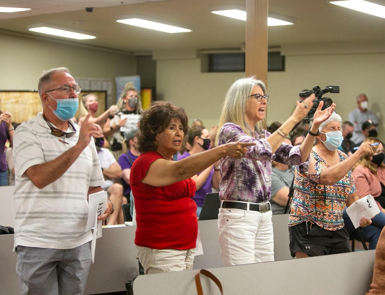 Community members boo a board member during a contentious Litchfield Elementary school board meeting on April 13, 2021.