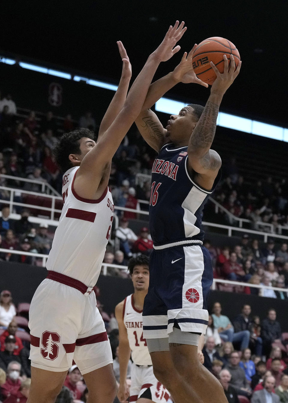 Arizona forward Keshad Johnson (16) shoots over Stanford forward Brandon Angel, left, during the first half of an NCAA college basketball game, Sunday, Dec. 31, 2023, in Stanford, Calif. (AP Photo/Tony Avelar)