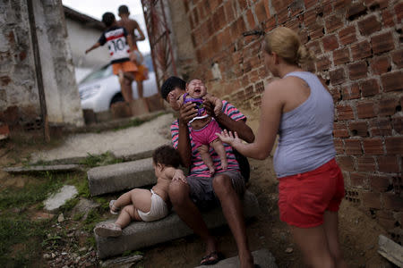 Gleyse Kelly da Silva holds Maria Giovanna, who has microcephaly, at their house in Recife, Brazil, January 30, 2016. REUTERS/Ueslei Marcelino/File Photo