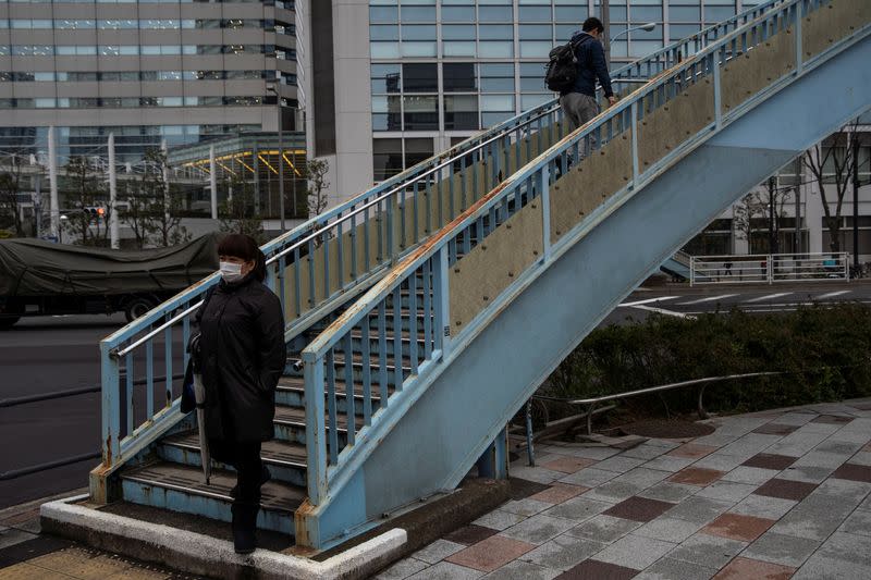 Woman wearing a face mask, following an outbreak of the coronavirus, is seen on a street in Tokyo