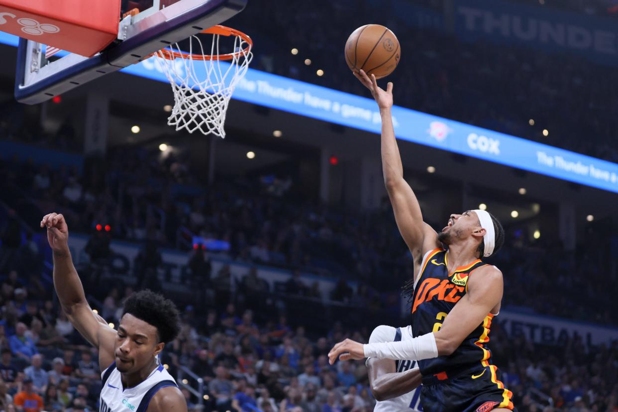 Oklahoma City Thunder guard Aaron Wiggins (21) puts up a shot during an NBA basketball game between the Oklahoma City Thunder and the Dallas Mavericks at Paycom in Oklahoma City, Sunday, April 14, 2024.