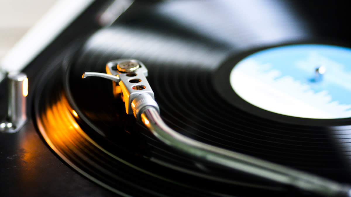  Close up of a tonearm over a vinyl record. 