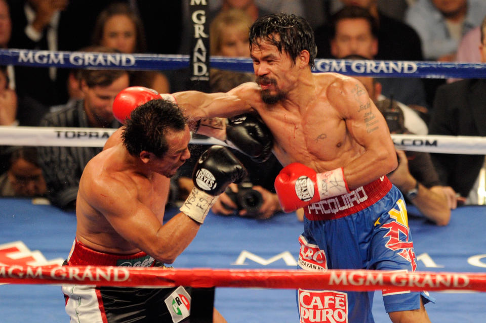 LAS VEGAS, NV - NOVEMBER 12: (R-L) Manny Pacquiao throws a right to the head of Juan Manuel Marquez during the WBO world welterweight title fight at the MGM Grand Garden Arena on November 12, 2011 in Las Vegas, Nevada. (Photo by Ethan Miller/Getty Images)