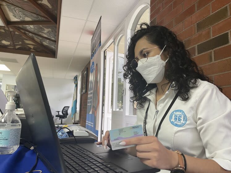 An employee of the Supreme Electoral Tribunal of Guatemala processes the data of Guatemalans in Los Angeles registering to vote in Guatemala's June 25 presidential election. <span class="copyright">(Soudi Jiménez / Los Angeles Times en Español)</span>