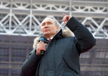 Russian President Vladimir Putin delivers a speech during a rally to support his bid in the upcoming presidential election, at Luzhniki Stadium in Moscow, Russia March 3, 2018. Sputnik/Alexei Nikolsky/Kremlin via REUTERS