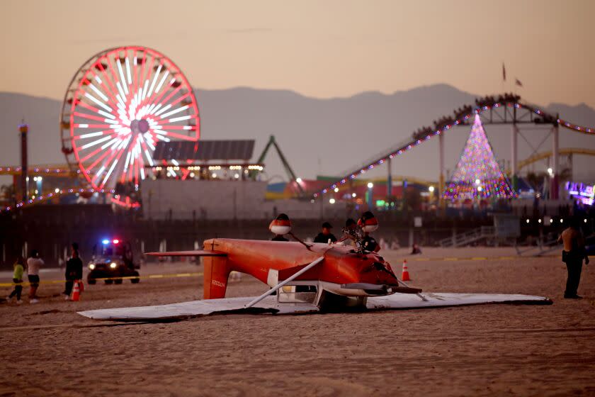 SANTA MONICA, CA - DECEMBER 22: An investigation in underway as a single-engine Cessna airplane flipped over after the pilot landed on the beach south of the pier on Thursday, Dec. 22, 2022 in Santa Monica, CA. Firefighters were called at 3:17 p.m. to the 1800 block of Santa Monica Beach, said Capt. Patrick Nulty, a spokesperson for the city's Fire Department. Both occupants were rescued and transported to a hospital. (Gary Coronado / Los Angeles Times)