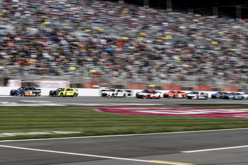 Joey Logano (22) leads the pack across the start/finish line during the NASCAR Cup Series auto race at Atlanta Motor Speedway, Sunday, March 19, 2023, in Hampton, Ga. (AP Photo/Butch Dill)