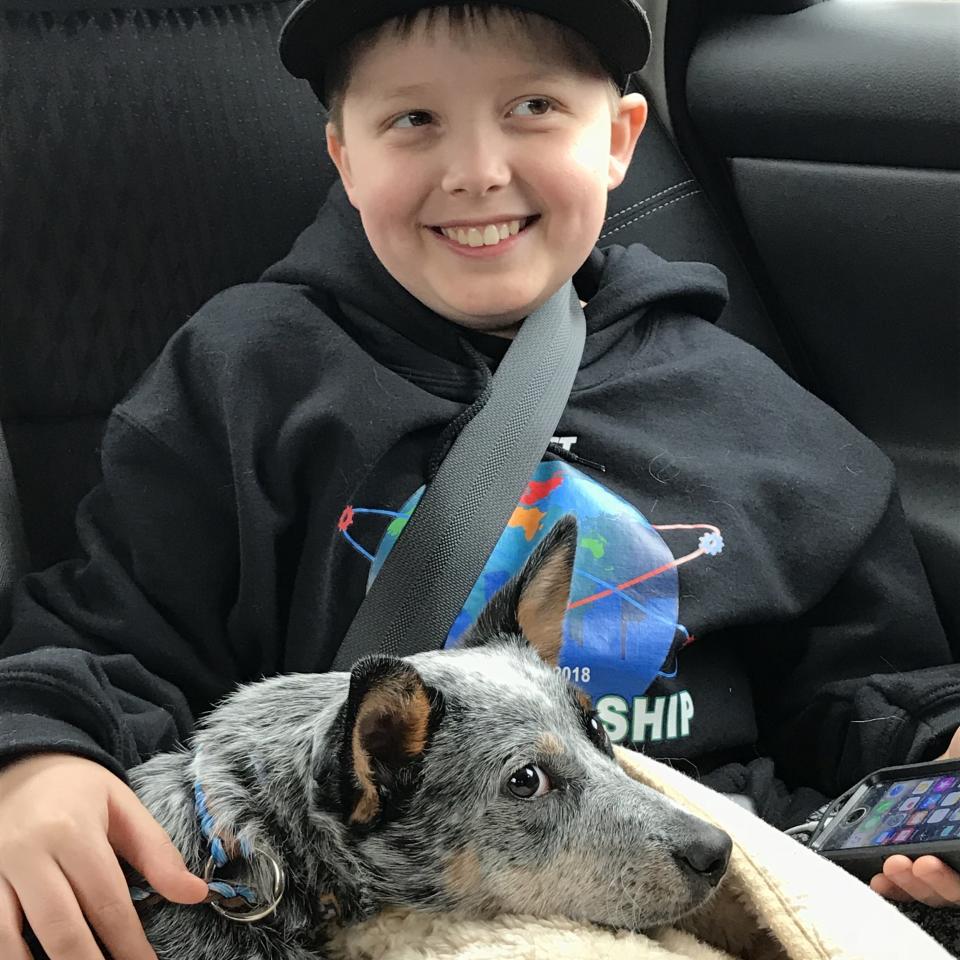 "This is Terabyte (Tera for short) and our youngest son. Tera is a cattle dog, found dumped in a field. She&rsquo;s super smart, sweet, snuggly, and also happens to be deaf. I took this photo right after we had signed the adoption papers and picked her up from her foster family." -- <i><a href="https://www.instagram.com/kristinchristopherjewelry/" target="_blank">Kristin Cooper</a>, Tera's mom</i>