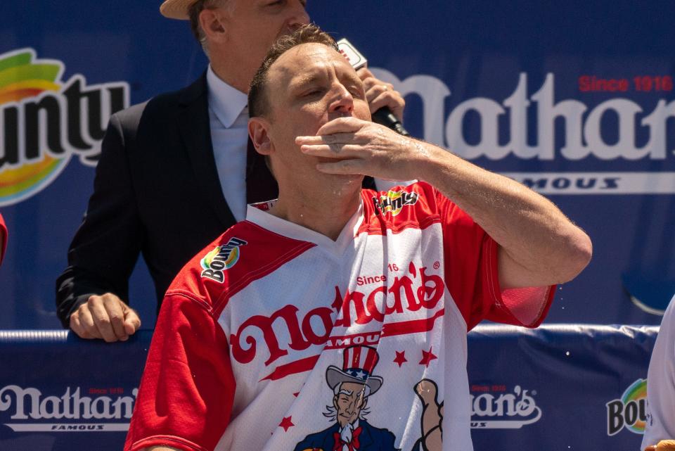 Competitive eating champion Joey "Jaws" Chestnut wins the 2021 Nathan's Hot Dog Eating Contest with 76 hot dogs, breaking his personal best record of 75, on July 4, 2021.