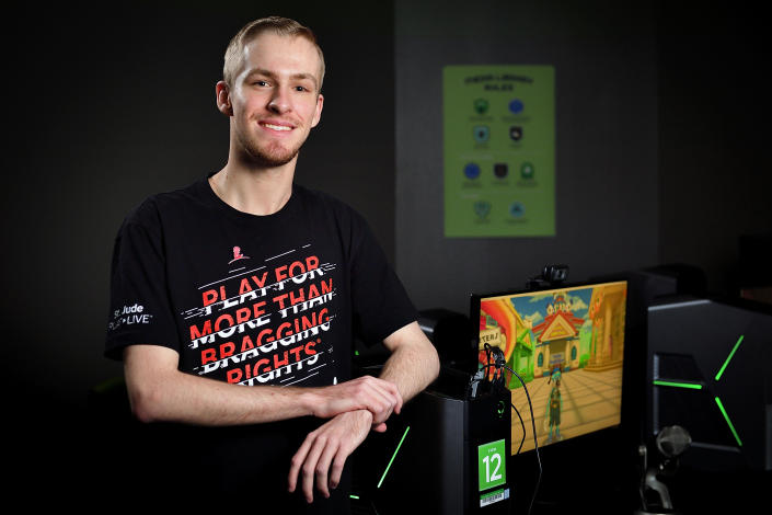 This photo provided by the University of North Texas shows student Michael Mairs in The Nest in the Media Library on the UNT campus in Denton, Texas on May 28, 2019. Mairs, 22, raises thousands of dollars for St. Jude Children’s Research Hospital by playing video games online as "Smirky." (Michael Clements/UNT via AP)
