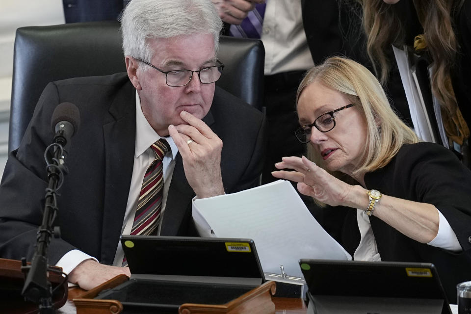 Texas Lt. Gov. Dan Patrick, left, talks with legal counsel Lana Myers, right, during the impeachment trial for suspended Texas Attorney General Ken Paxton in the Senate Chamber at the Texas Capitol, Thursday, Sept. 14, 2023, in Austin, Texas. (AP Photo/Eric Gay)