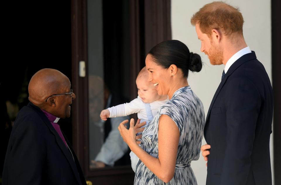 To kick off the third day of their royal South Africa tour, Prince Harry introduced Meghan and his almost 5-month-old son Archie to an old friend. On Wednesday morning, the little royal was taken by his parents for his first official royal engagement to meet with famed anti-apartheid activist Archbishop Desmond Tutu and his daughter, Thandeka Tutu-Gxashe.