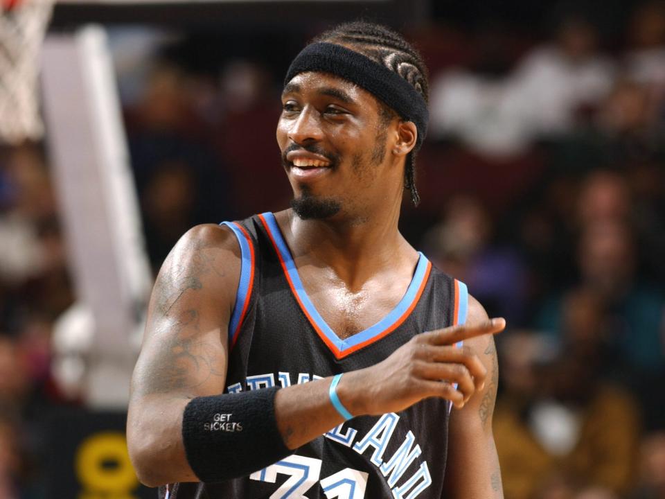 Ricky Davis smiles and points during a game in 2003.