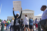 Kelli Midgley, center, an English teacher from Baltimore, joins people gathered at the Supreme Court to honor the late Justice Ruth Bader Ginsburg in Washington, Saturday, Sept. 19, 2020. Ginsburg's death leaves a vacancy that could be filled by a more conservative justice by President Donald Trump. (AP Photo/J. Scott Applewhite)