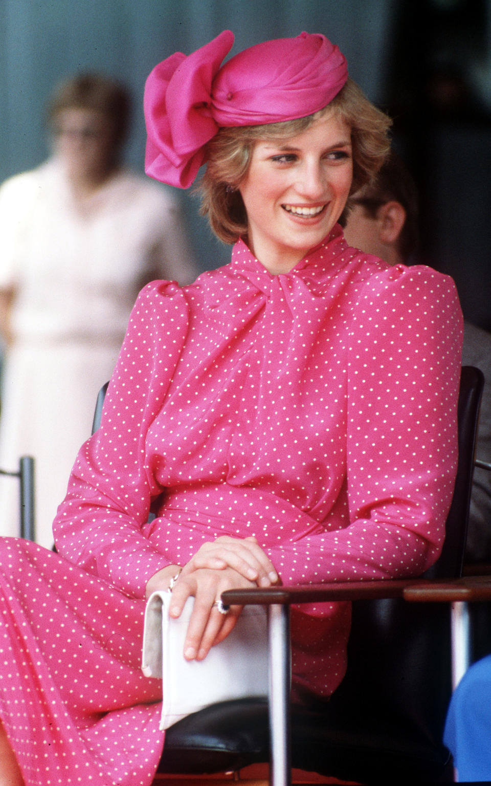 Princess Diana sitting in pink dress