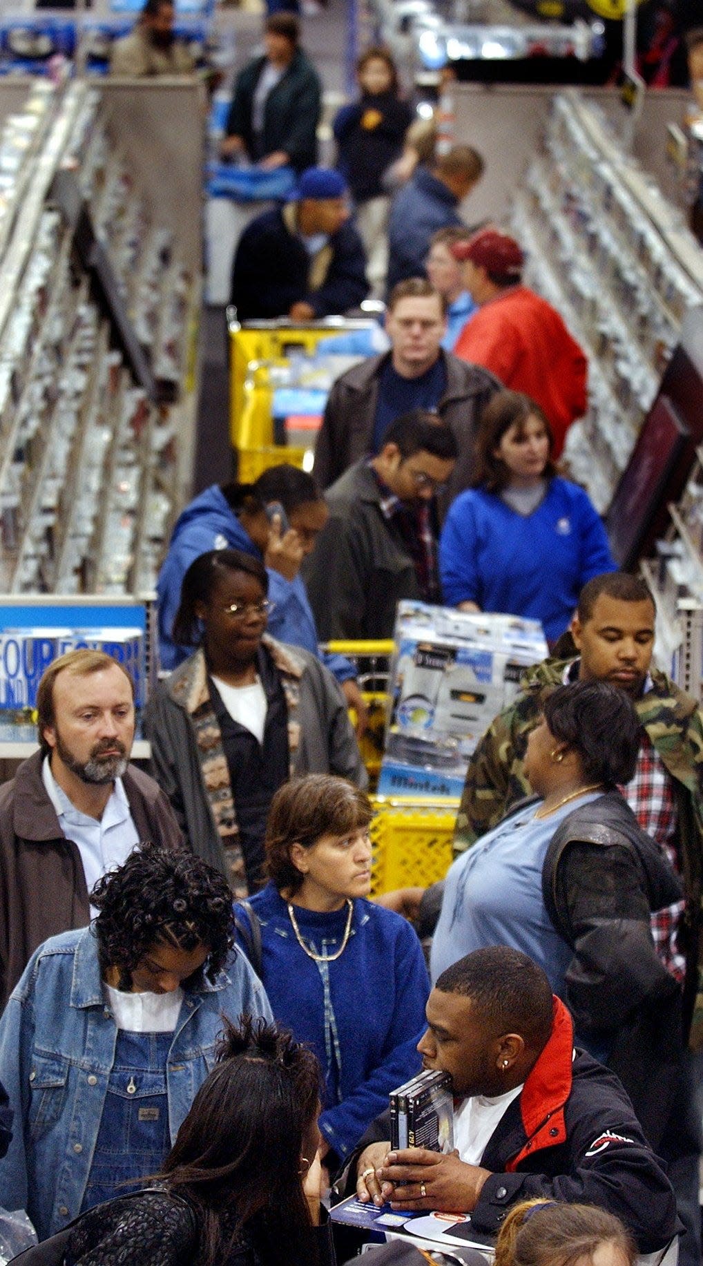 Shoppers wait to cash out in a line that stretches down the aisle at Best Buy on Black Friday in 2002. Today, many holiday deal seekers shop online instead of heading to a store.