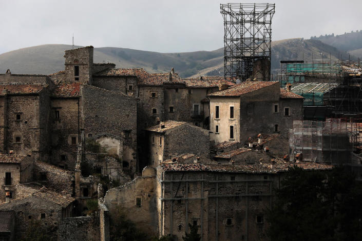 <p>Metal frames support what is left of a medieval tower, as work is in progress to reconstruct it after it collapsed in the 2009 earthquake, in Santo Stefano di Sessanio in in the province of L’Aquila in Abruzzo, inside the national park of the Gran Sasso e Monti della Laga, Italy, September 22, 2016. (Photo: Siegfried Modola/Reuters) </p>