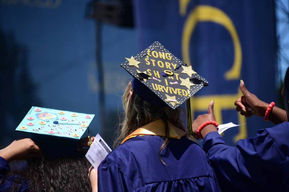 UC Merced graduate Tea Pusey’s message on her graduation cap ready: “Long story short I survived.”