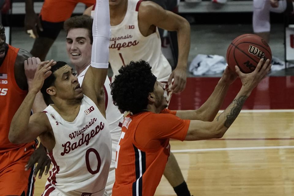 Illinois's Andre Curbelo drives past Wisconsin's D'Mitrik Trice during the first half of an NCAA college basketball game Saturday, Feb. 27, 2021, in Madison, Wis. (AP Photo/Morry Gash)