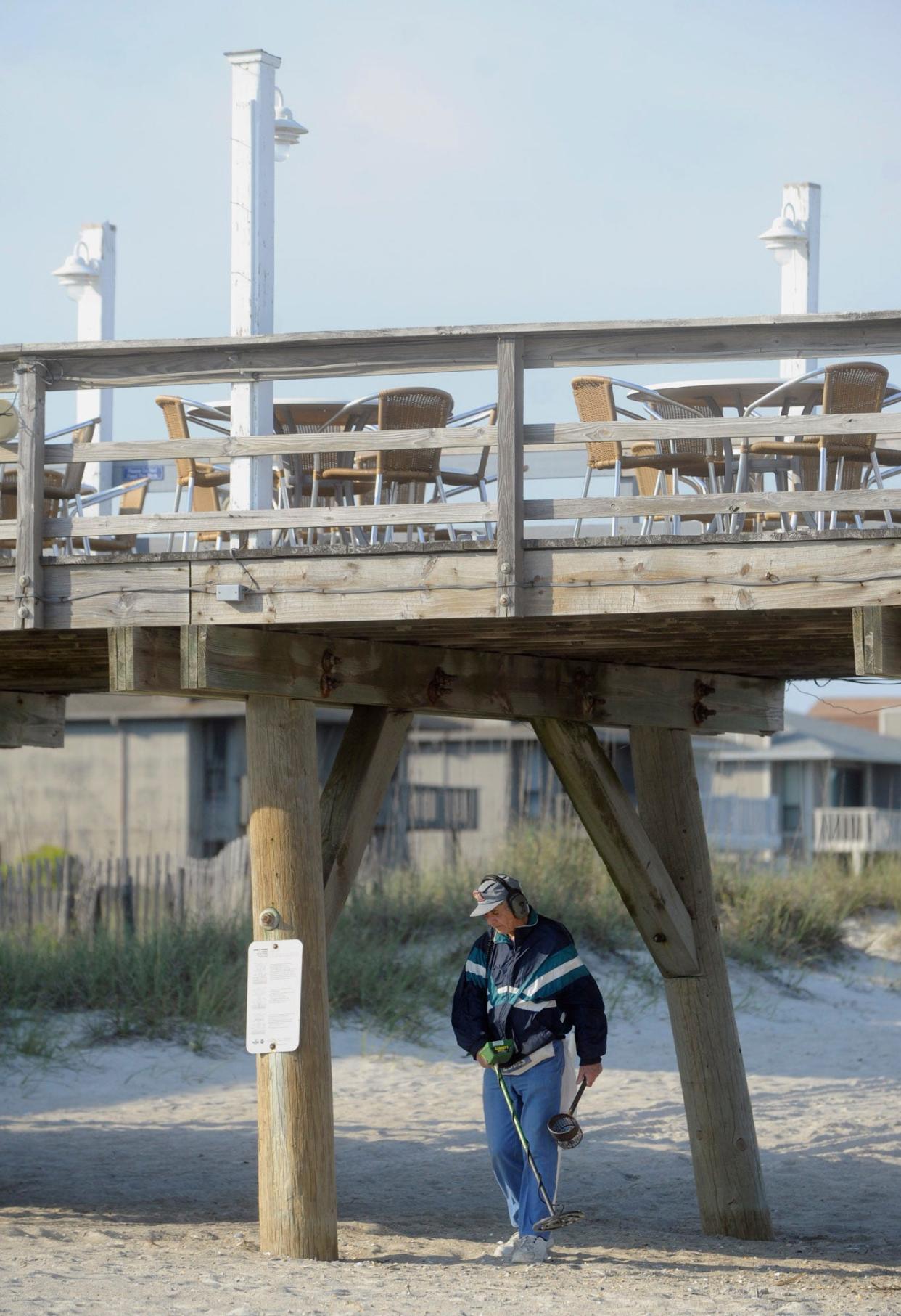 Local treasure hunter George Lapinsky uses his metal detector to search the sand at Wrightsville Beach's Crystal Pier. If you're looking for a unique activity with the possibility of finding treasurers, give it a try yourself.