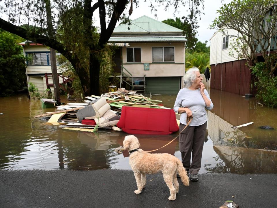 Local resident Cathy Jordan inspects floodwater in her street in Lismore after it was submerged in March (Getty Images)