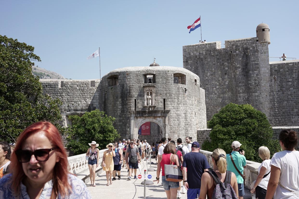 Tourists walk through the Pile Gate in Croatia