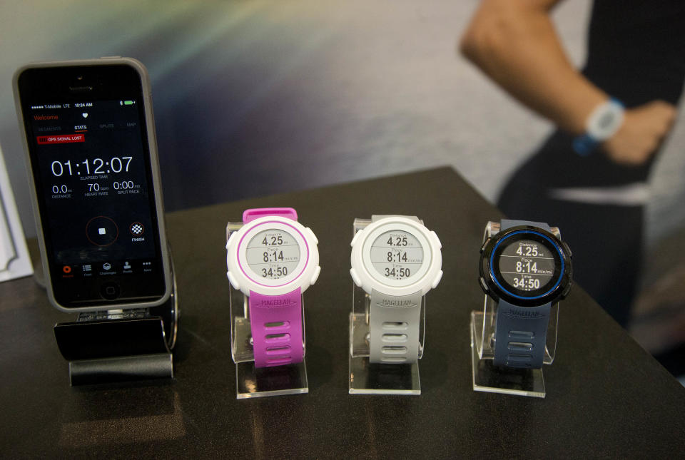 Magellan Echo smart sports watches sit on display at the International Consumer Electronics Show, Wednesday, Jan. 8, 2014, in Las Vegas. The watch can sync with mobile devices to make the most out of the user's sports apps. (AP Photo/Julie Jacobson)