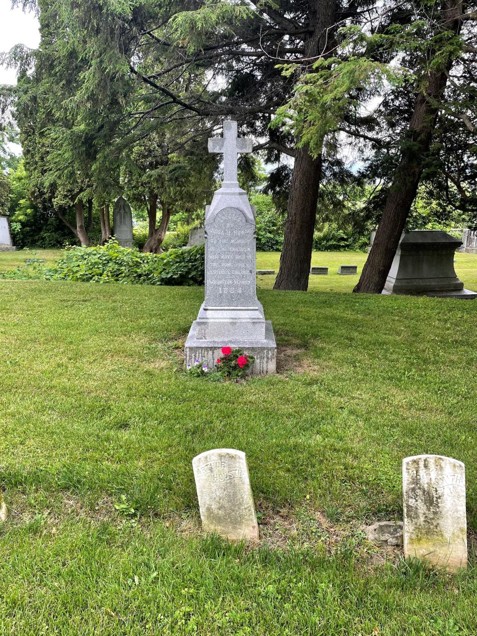 A Lakeview Cemetery stone reads "Erected by Louisa H. Howard To the memory of the children who have died in the Home For Destitute Children - Burlington, Vermont 1884." The stone marks a section of Lakeview Cemetery which includes nearly 50 headstones. The children's headstones from the late-1800s are being restored on Sept. 10, 2022.