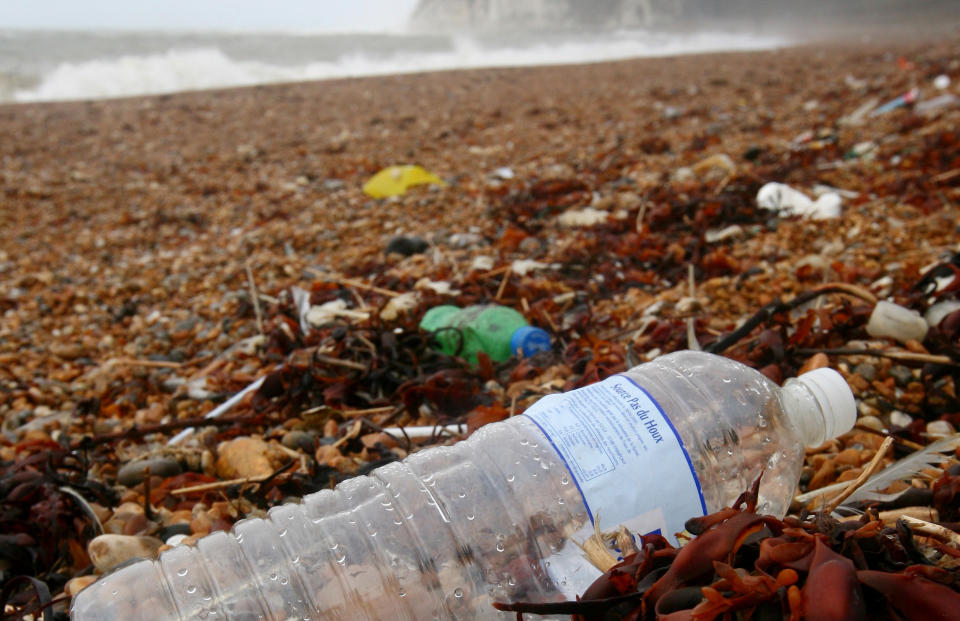 Single-use plastic bottle on a beach.