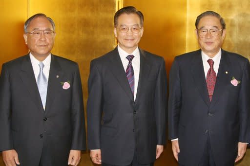 This file photo shows Chinese PM Wen Jiabao (C) posing for a photo with Japanese economic leaders, head of the Japan Business Federation Fujio Mitarai (L) and Fujio Cho, chairman of Japan-China economic association, prior to a luncheon in Tokyo, in 2007