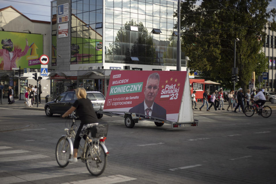 A car carries a trailer with a political campaign billboard for left-wing candidate Wojciech Konieczny in Czestochowa, Poland, Tuesday, Oct. 3, 2023. As the ruling conservative Law and Justice party seeks to win an unprecedented third straight term in the Oct. 15 parliamentary election, it has sought to bolster its image as a defender of Christian values and traditional morality. Yet more and more Poles appear to be questioning their relationship with the Catholic church, and some cite its closeness to the government as a key reason. (AP Photo/Michal Dyjuk)