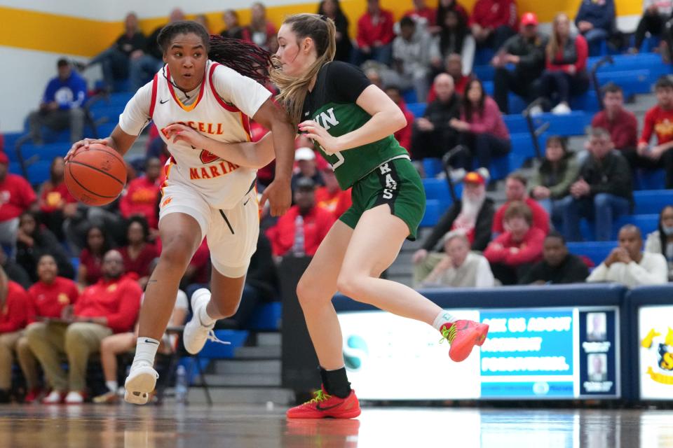 Purcell Marian guard Dee Alexander dribbles down the court as Badin Rams forward Gracie Cosgrove defends in the regional finals, Friday, March 8, 2024, at Springfield High School.