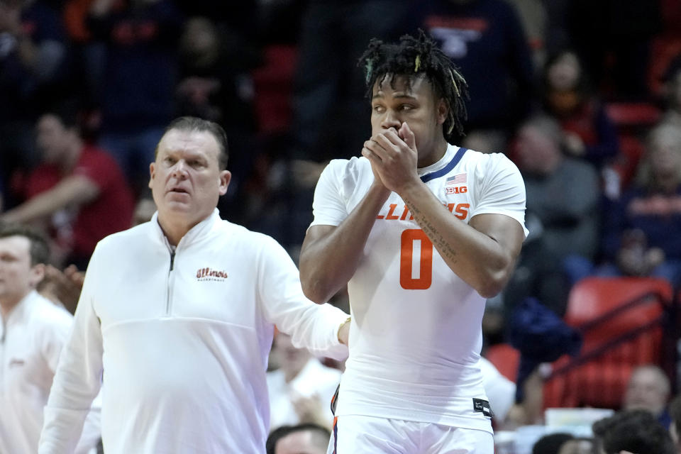 Illinois' Terrence Shannon Jr. prepares to enter the game as head coach Brad Underwood watches during the first half of an NCAA college basketball game against Rutgers Sunday, Jan. 21, 2024, in Champaign, Ill. A federal judge has reinstated Shannon Jr., who had been suspended from the team since he was charged with rape in Kansas last fall. (AP Photo/Charles Rex Arbogast)