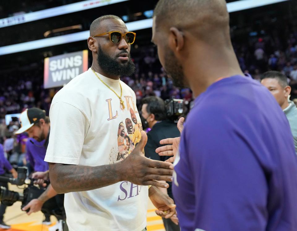 Apr 5, 2022; Phoenix, Arizona, United States; Los Angeles Lakers forward LeBron James shakes hands with Phoenix Suns guard Chris Paul after losing 121-110 at Footprint Center.