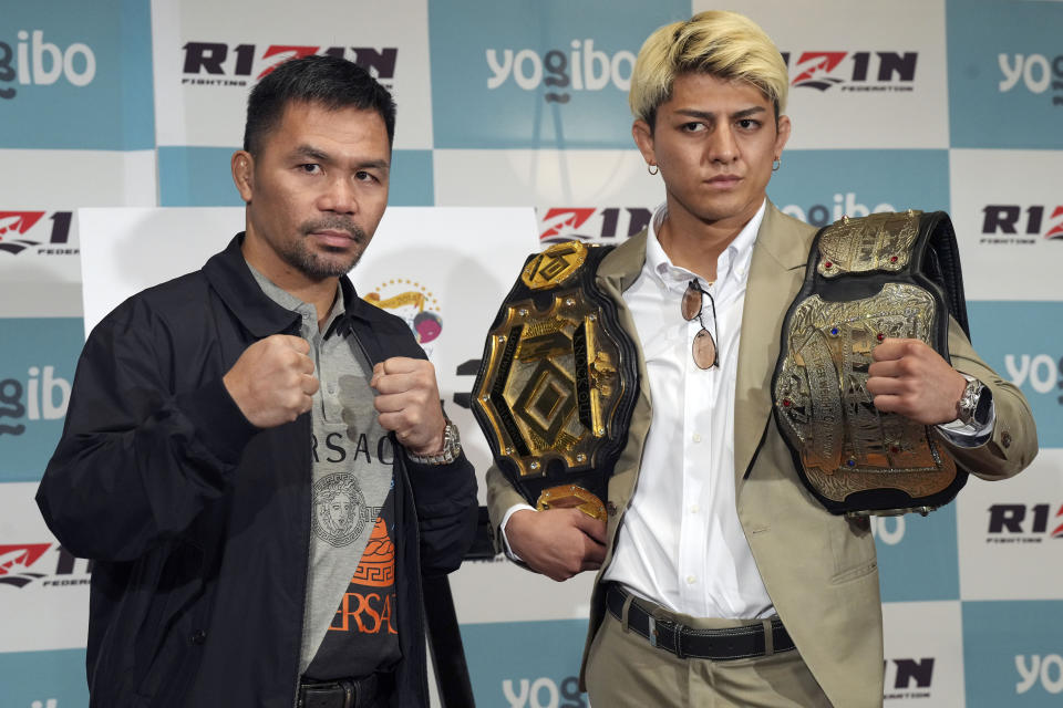 Former Filipino boxer Manny Pacquiao, left, and Japanese mixed martial arts fighter Chihiro Suzuki pose during a press conference Monday, June 10, 2024, in Tokyo. They are scheduled to fight in a three-round match in July. (AP Photo/Eugene Hoshiko)