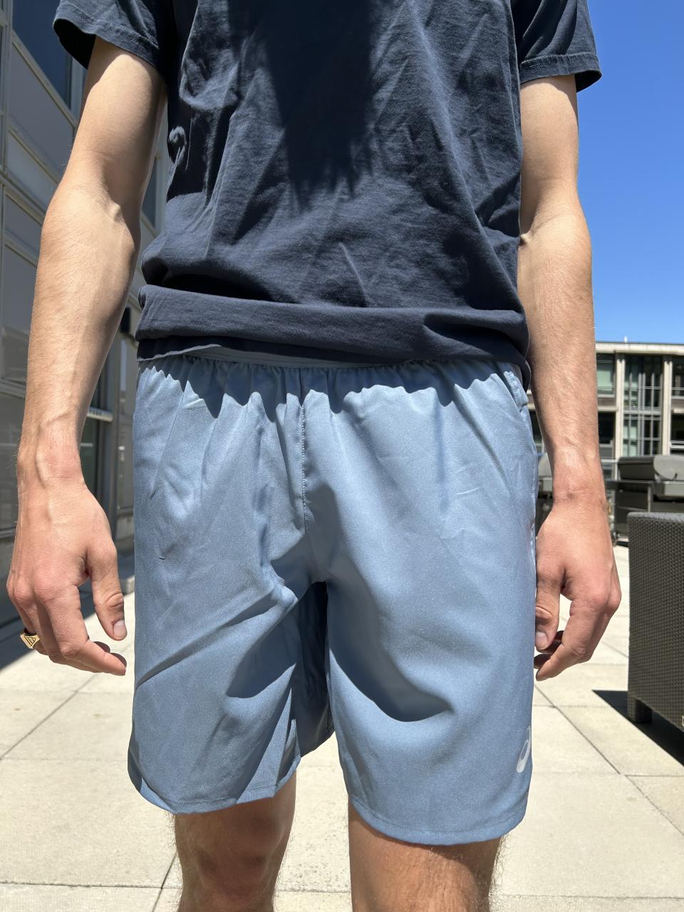 man wearing navy t-shirt and light blue shorts 