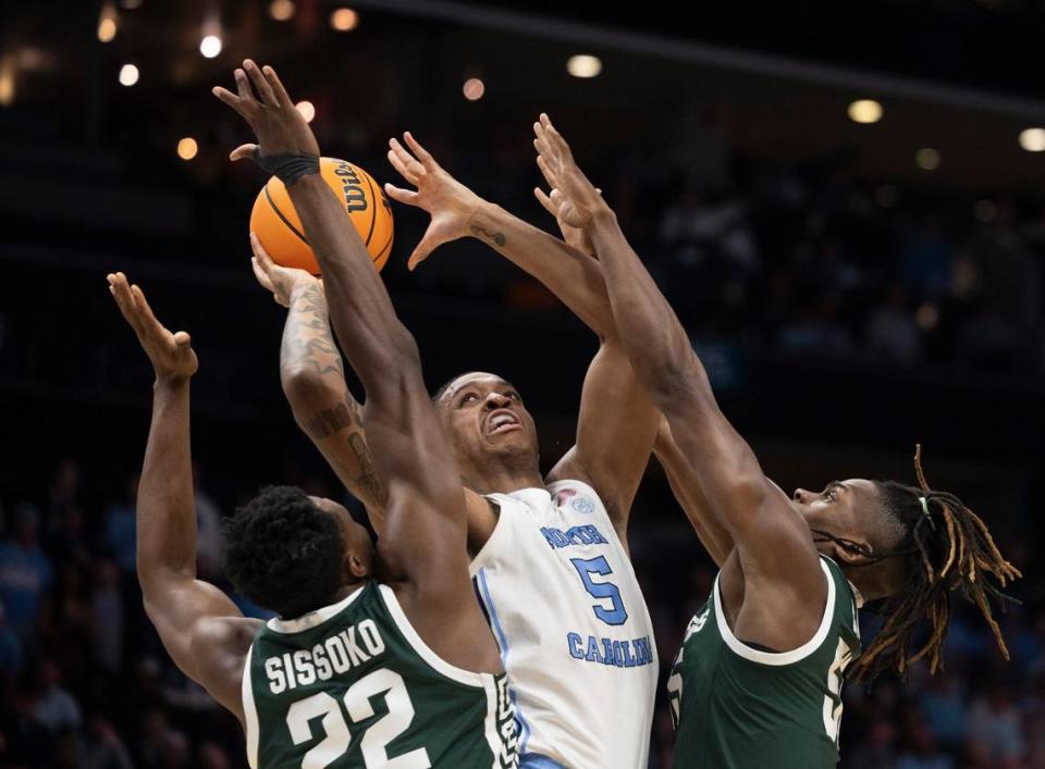 North Carolina's Armando Bacot (5) shoots a basket in the first half against Michigan State's Mady Sissoko (22) and Coen Carr (55) during the second round of the NCAA Tournament at the Spectrum Center in Charlotte, NC on Saturday, March 23, 2024.