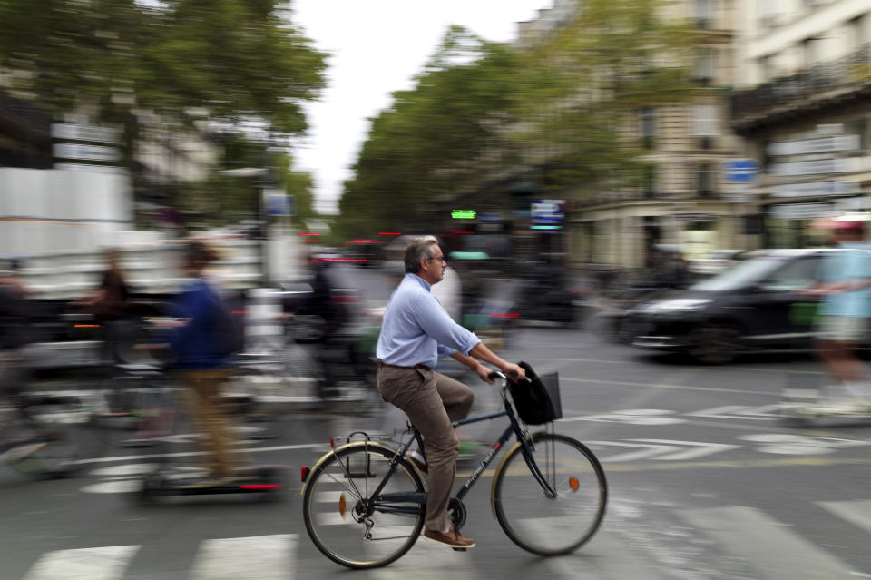 A man rides a bicycle in a street of Paris, Friday, Sept. 13, 2019. Paris metro warns over major strike, transport chaos Friday. (AP Photo/Thibault Camus)