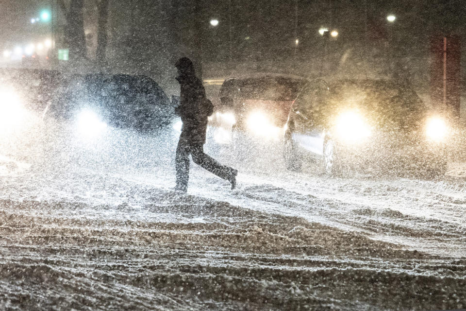 A person crosse a street during heavy snowfall in Aalborg, northern Jutland, Denmark, Wednesday, Jan. 3, 2024. Temperatures have fallen below minus 40 degrees Celsius in the Nordic region for a second day in a row, with the coldest January temperature recorded in Sweden in 25 years as a cold spell grips the area. (Henning Bagger/Ritzau Scanpix via AP)